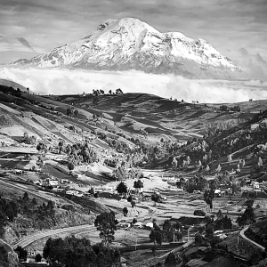 A verdant patchwork valley leads to a stunning view of Chimborazo in Ecuador